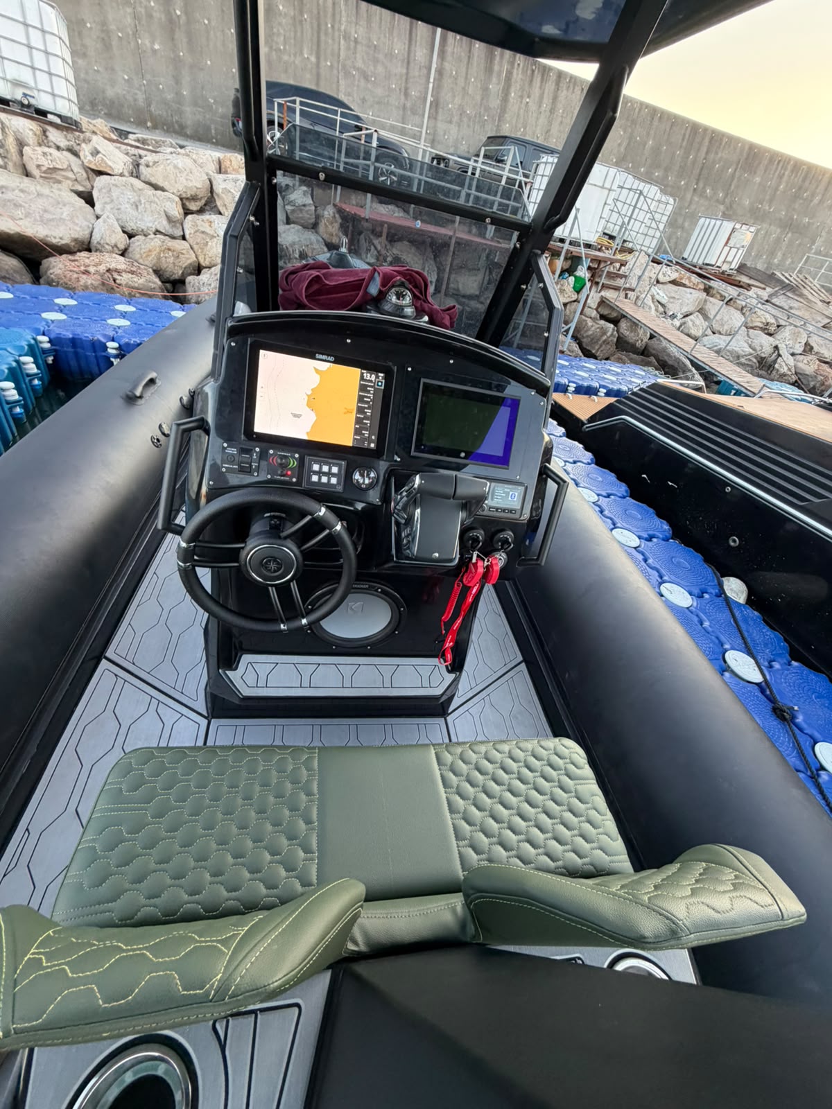 Helm console with Simrad chartplotter and sport steering wheel